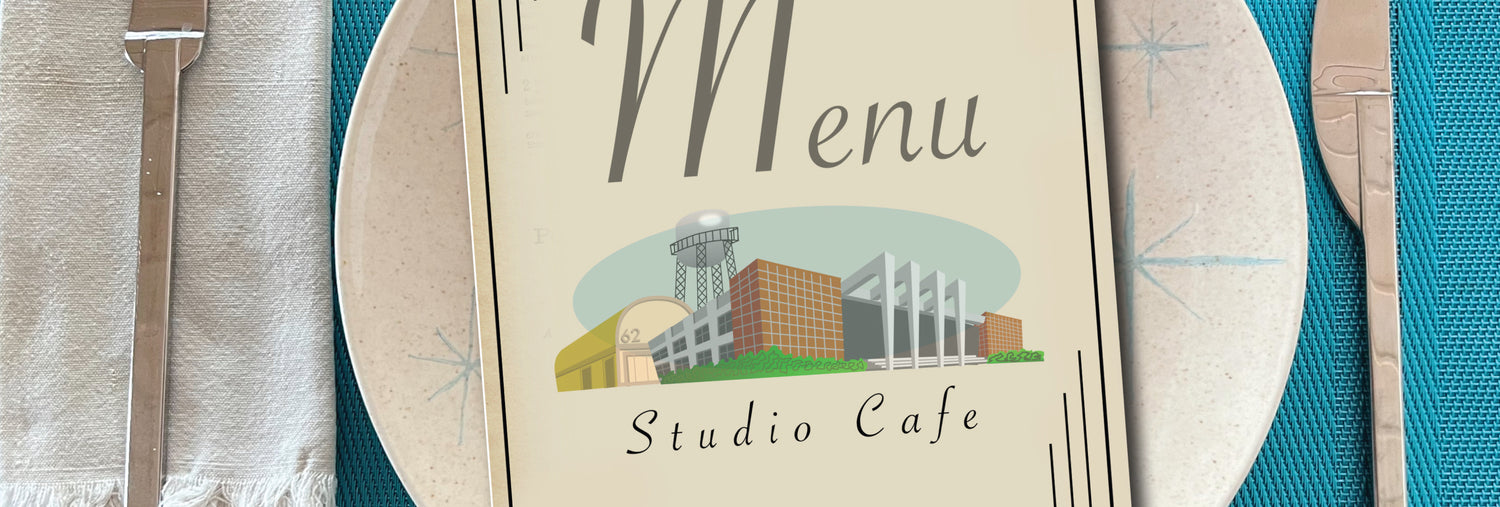 Image of a place setting, with a fictional studio commissary menu on top.